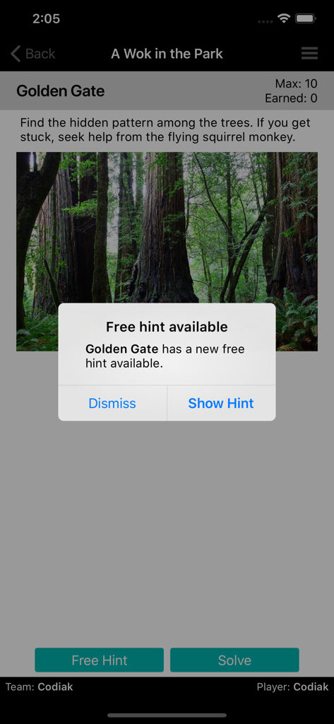 ClueKeeper - ClueKeeper app interface showing a forest clue challenge with a free hint notification popup.