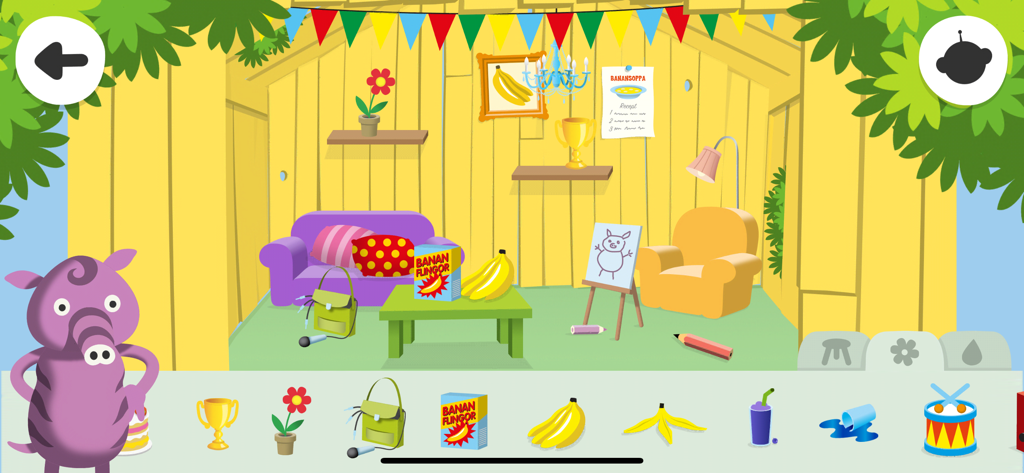 Radioapans kojträd - A colorful treehouse interior in the Radioapans kojträd app where children can decorate a yellow room with objects like bananas, trophies, and furniture.