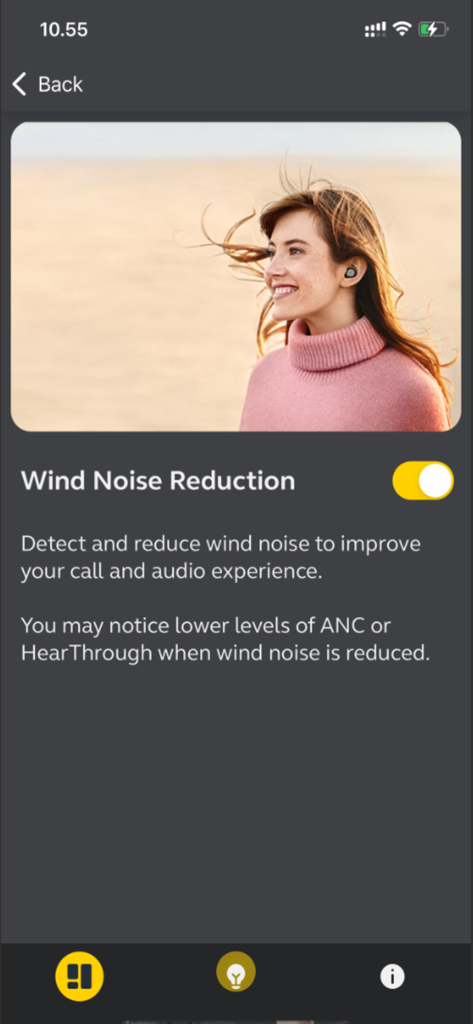Jabra Sound Plus app screen showing the Wind Noise Reduction toggle turned on with a descriptive text and an image of a woman wearing an earbud.