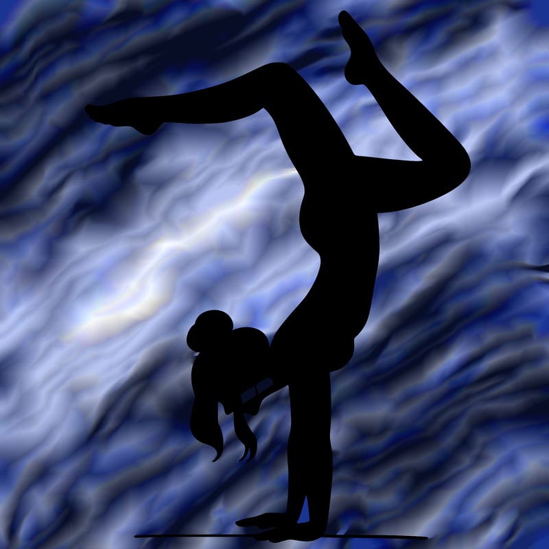 a woman doing a handstand