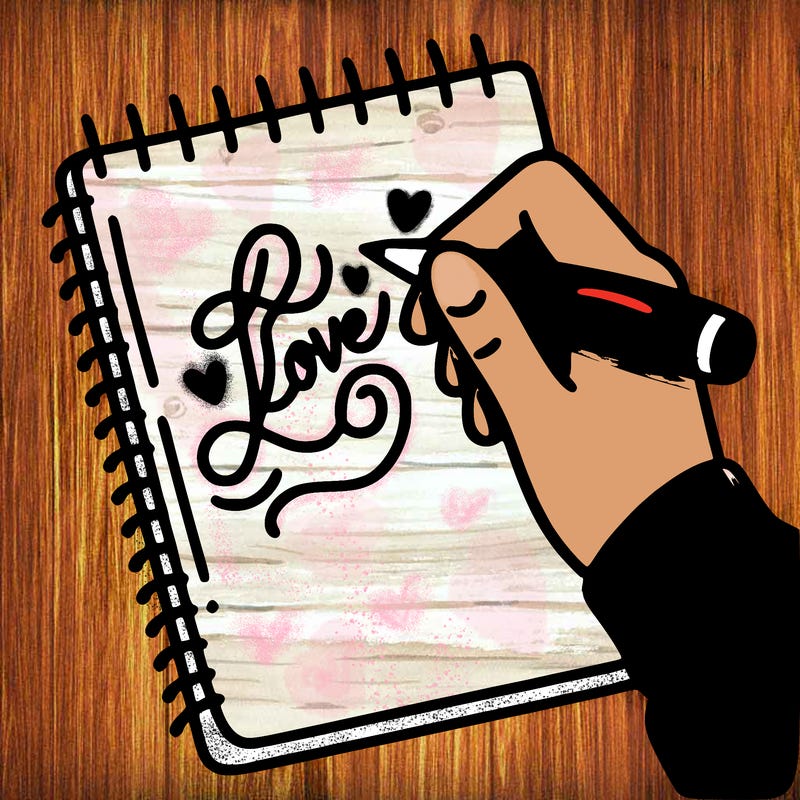 a hand writing “love” in calligraphy on a notebook