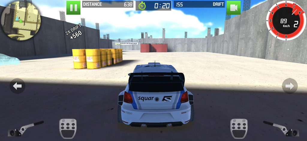 Rally Racer Dirt - A white rally car drifting in an industrial area with yellow barrels in the Rally Racer Dirt mobile game