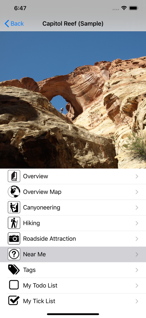 Road Trip Ryan Trip Guide - Road Trip Ryan app screen for Capitol Reef adventure guide with a photo of a rock arch and menu options for canyoneering and hiking.