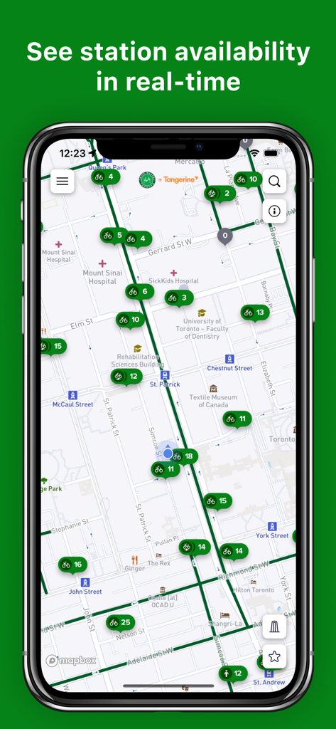 A smartphone displaying the Bike Share Toronto interactive map with real-time station and bike availability icons in downtown Toronto.