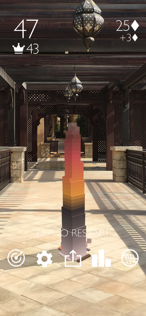 Stack AR - Augmented reality gameplay of Stack AR showing a tower of colorful blocks in an outdoor hallway.
