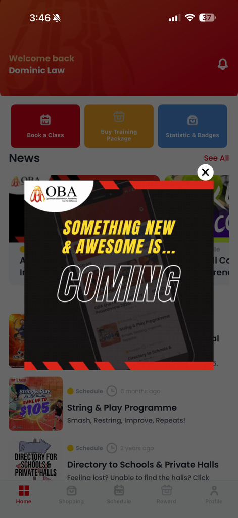 OBA Badminton App (New) - OBA Badminton App home screen featuring a promotional pop-up announcement and quick access buttons for booking classes and buying training packages.
