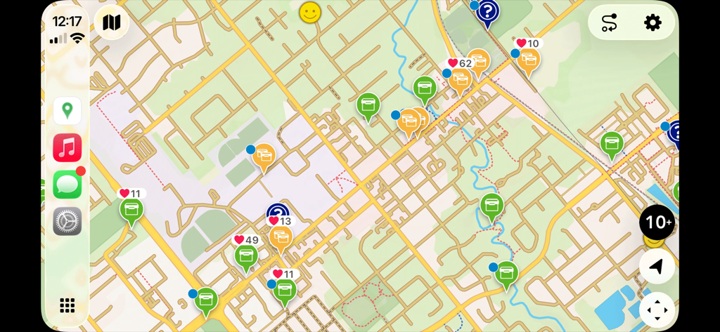 Cachly geocaching app interface on Apple CarPlay showing a detailed map with various cache icons and favorite points.
