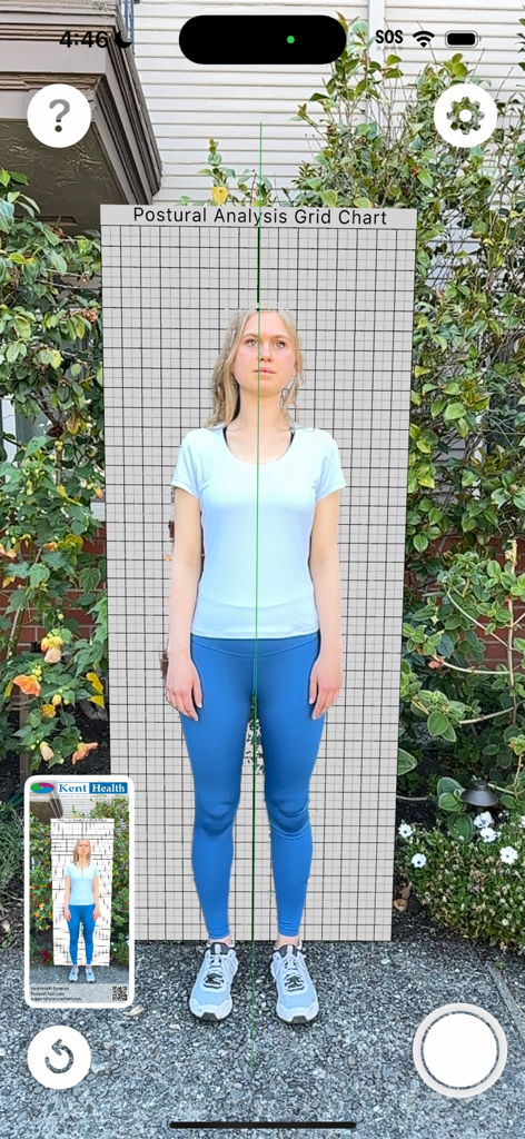 Posture Chart - A woman standing behind a digital postural analysis grid in the Posture Chart mobile app