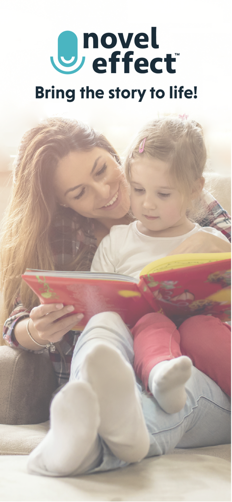 A mother and young daughter reading a physical book together on a couch