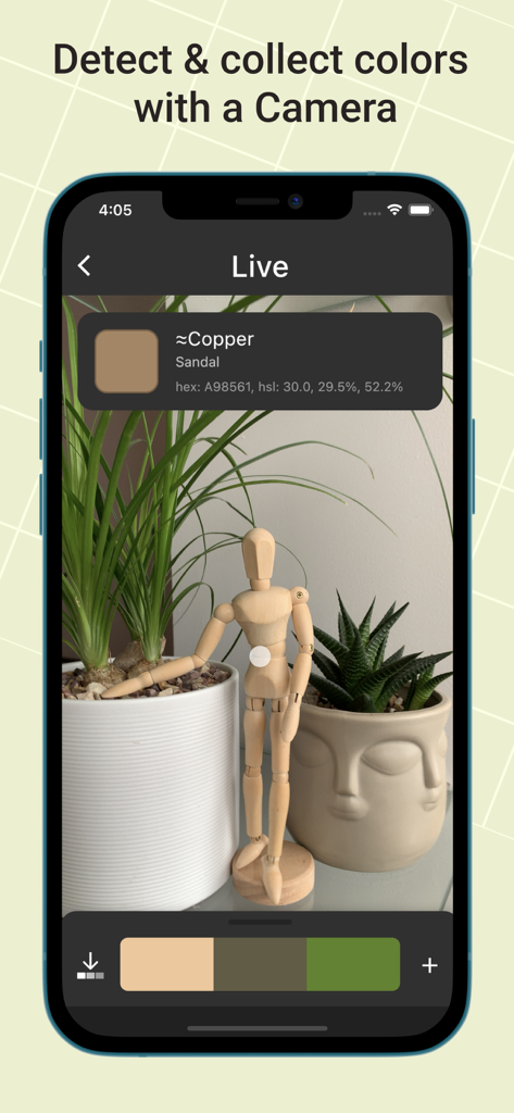 Color Picker: Grab Palette - Smartphone app screen showing live AR color detection using the camera to identify colors from a wooden mannequin and plants.