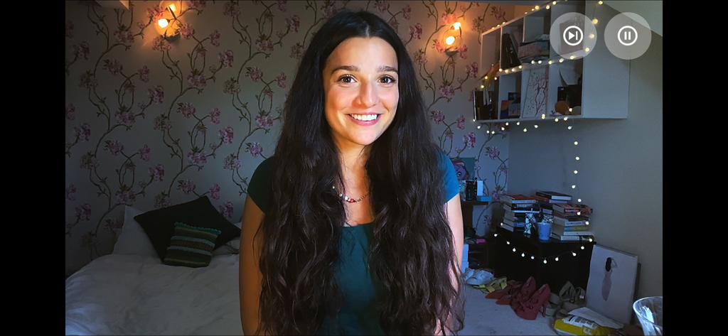 A smiling woman on a video call in the Five Dates interactive game