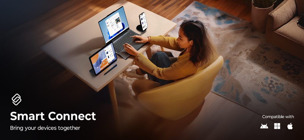 A woman at a desk using Lenovo Smart Connect to sync her laptop tablet and smartphone