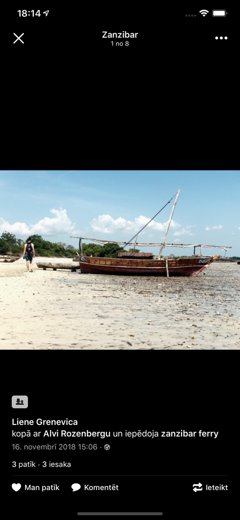 Draugiem app interface showing a photo of a wooden boat on a beach in Zanzibar