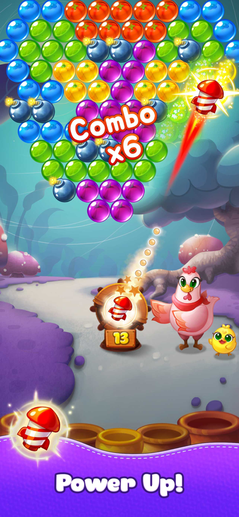 A pink hen uses a rocket booster power up to clear fruit bubbles in the Bubble CoCo match 3 shooter game