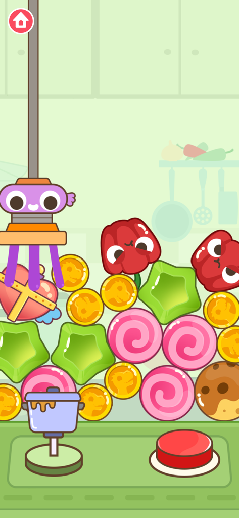 Una colorata gru digitale per bambini con vari dolciumi e monete premio in un livello a tema cucina.