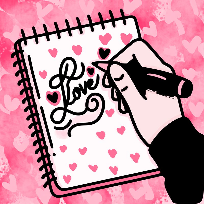 a hand writing “love” in calligraphy on a notebook