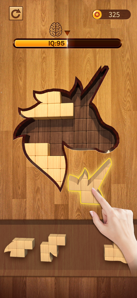 Hand dragging a wooden block into a unicorn shaped puzzle frame in the BlockPuz app