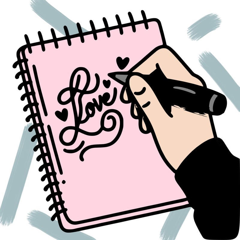 a hand writing “love” in calligraphy on a notebook