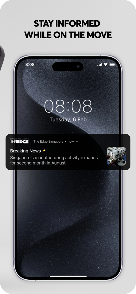 A smartphone displaying a breaking news notification from The Edge Singapore app