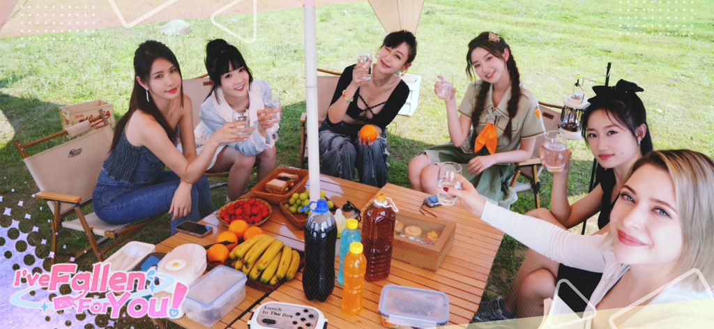 A group of young women enjoying an outdoor picnic with fruit and drinks in the dating sim Fallen For You.