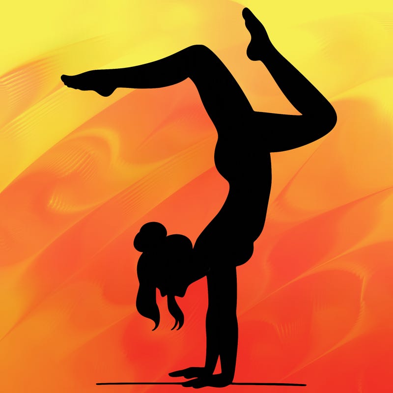 a woman doing a handstand