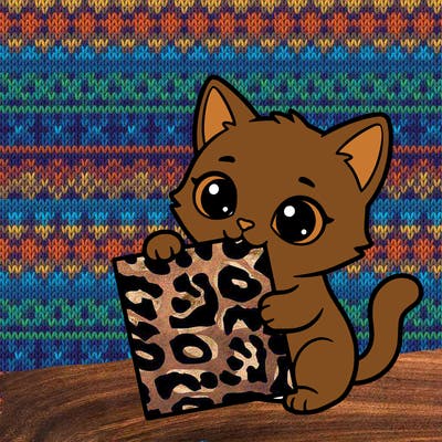 a small cat with a blank sheet of paper in its hand. the cat is sooooooo cute!