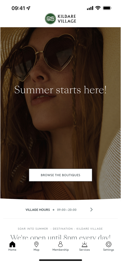 Home screen of the Kildare Village app showing summer campaign and main navigation menu