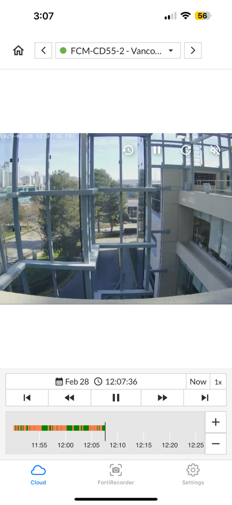 FortiCamera - FortiCamera app interface showing recorded security footage of an office building with playback controls and timeline