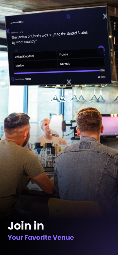 People at a bar participating in an Atmosphere Trivia game on a large TV screen.
