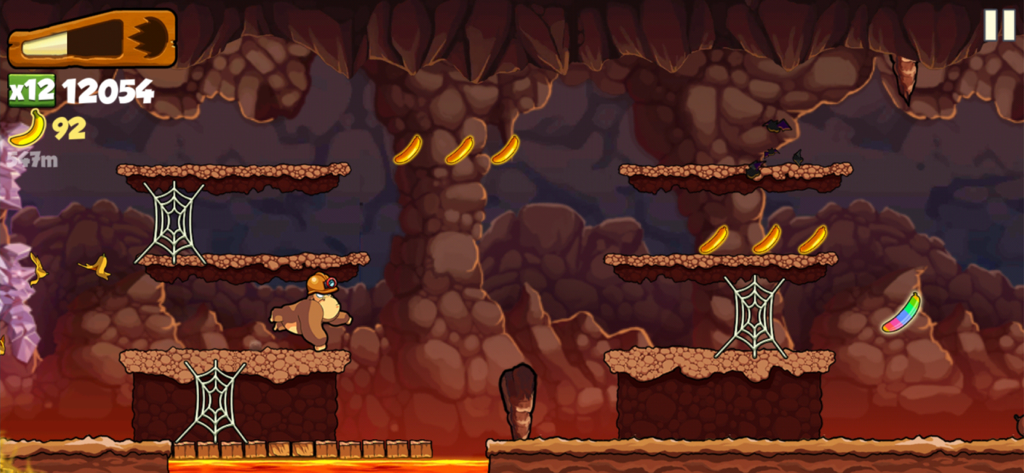 Banana Kong - Banana Kong character running in an underground cave level with bananas and spiderwebs