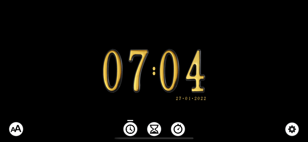 Digital clock display with a decorative golden font on a black background showing the time 07:04