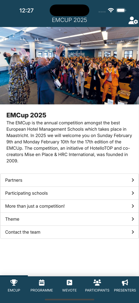 EMCup - Home screen of the EMCup 2025 app showing event details and a cheering crowd of hospitality students.