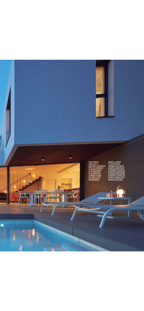 Casa Viva - Modern luxury home exterior featuring a swimming pool and outdoor lounge at dusk.