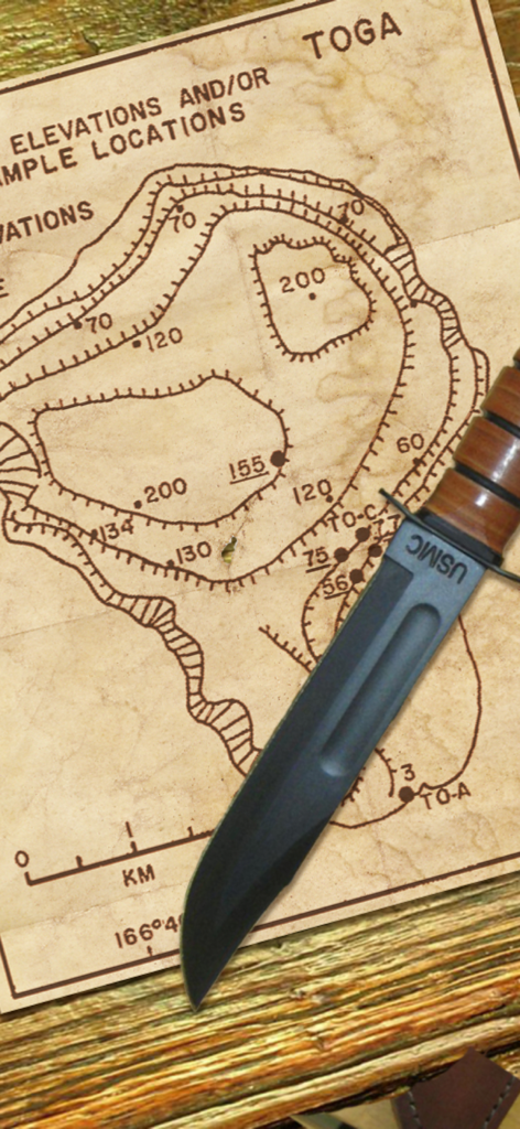 Marine Raider - USMC combat knife on a World War II topographical battle map.