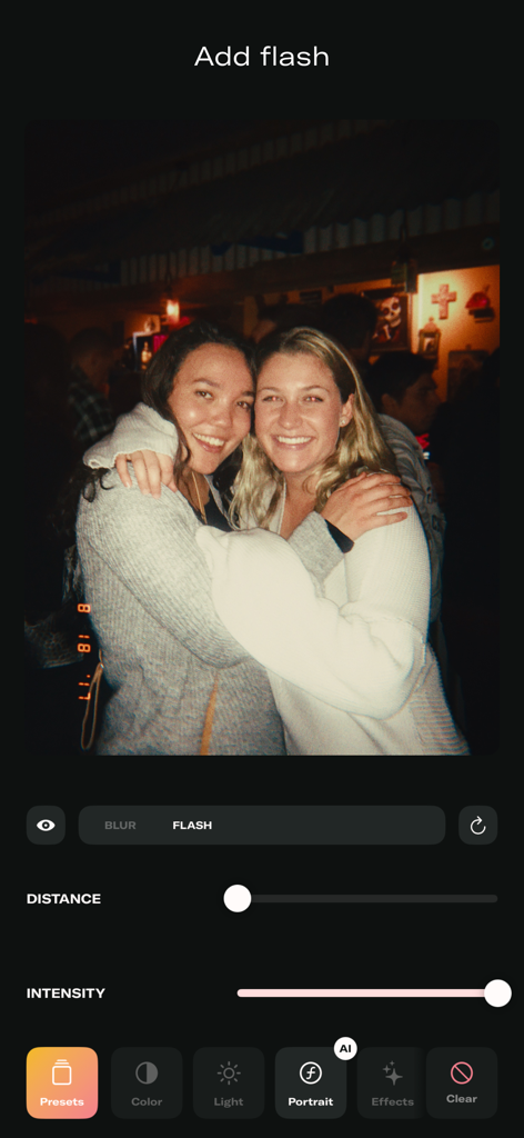 Mobile app interface showing a vintage flash effect being applied to a portrait photo of two friends.