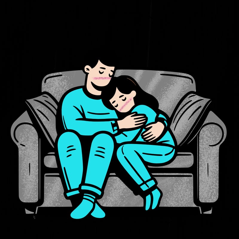 a couple hugging on a couch