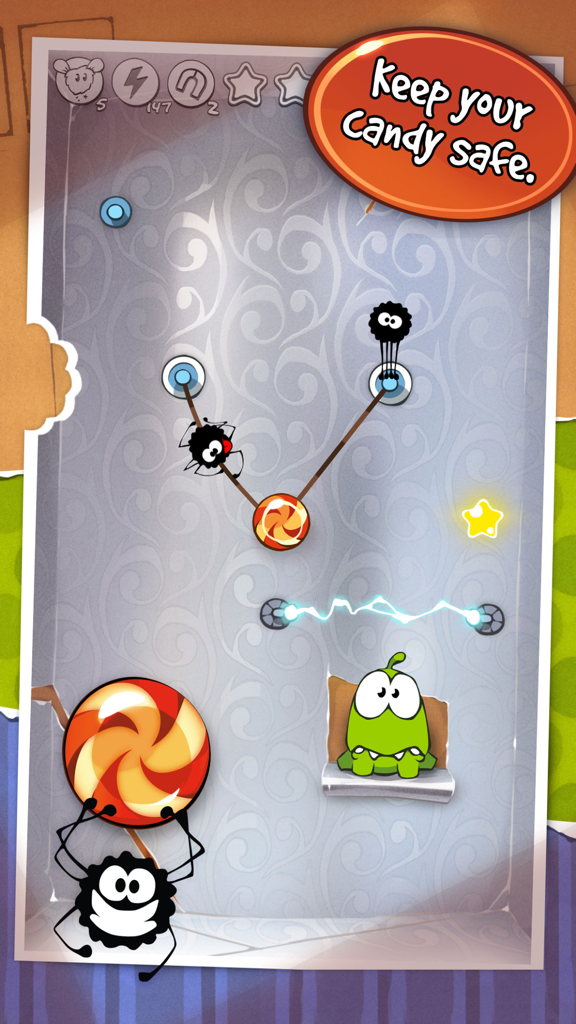Cut the Rope GOLD - Gameplay screenshot of Cut the Rope GOLD showing spiders crawling on ropes toward the candy above Om Nom