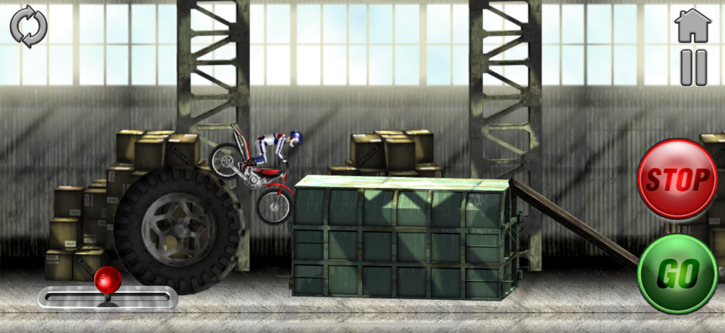 A trial bike rider navigating crates and giant tires in an industrial zone level of Bike Mania 2