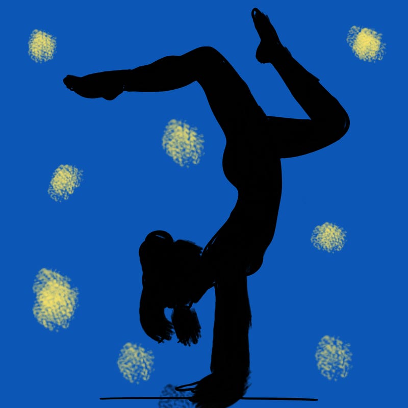 a woman doing a handstand