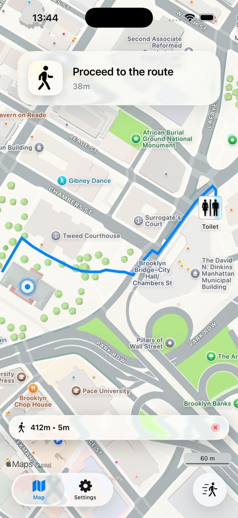 Mobile app showing a walking route to the nearest public toilet on an urban map
