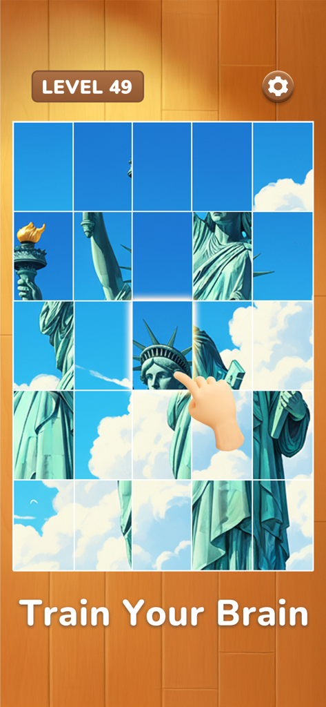 Daily Jigsaw - Zen Puzzles - A hand solving a Statue of Liberty jigsaw puzzle in the Daily Jigsaw app with the text train your brain