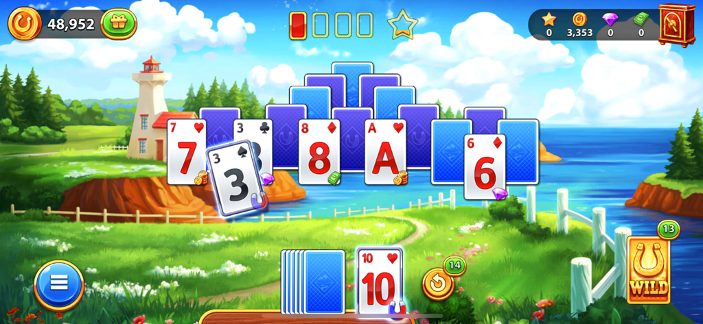 Solitaire Golden Prairies game level showing tripeaks cards and a scenic farm background with a lighthouse