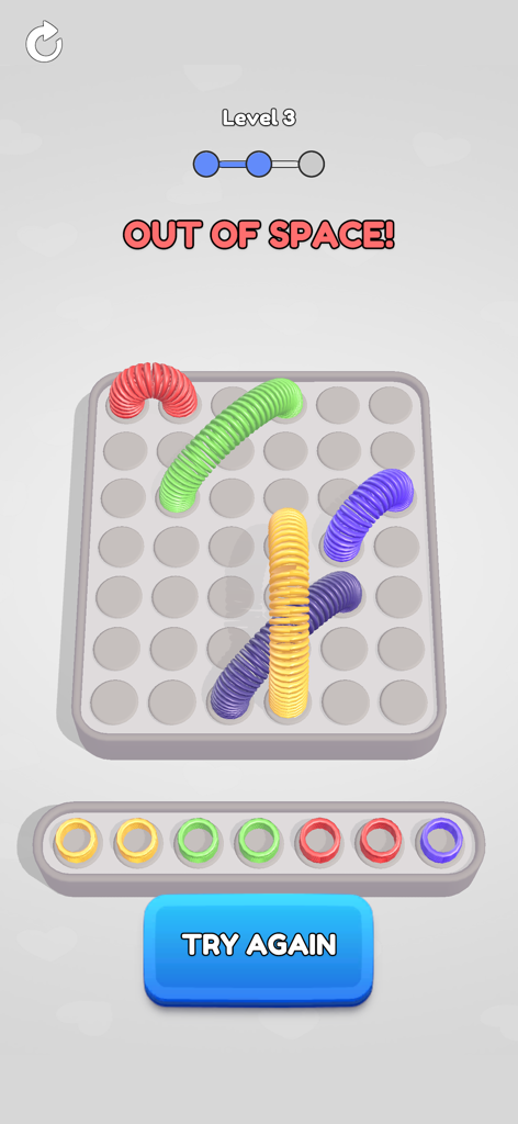 Gameplay screen of Slinky Jam showing an out of space message and colorful slinkies on a grid