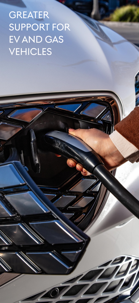 Genesis Intelligent Assistant - Person plugging a charging cable into a white Genesis electric vehicle with text mentioning support for EV and gas models