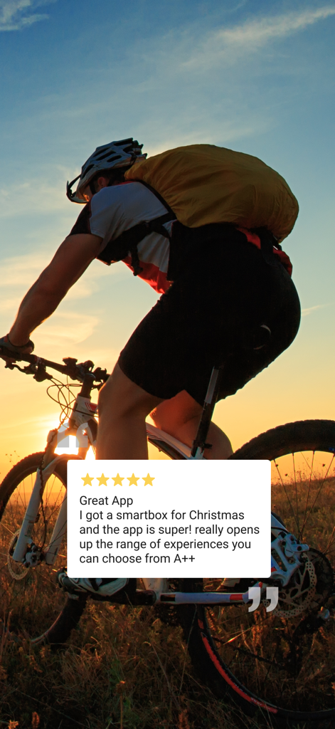 A person mountain biking at sunset with a five star user review of the Smartbox app