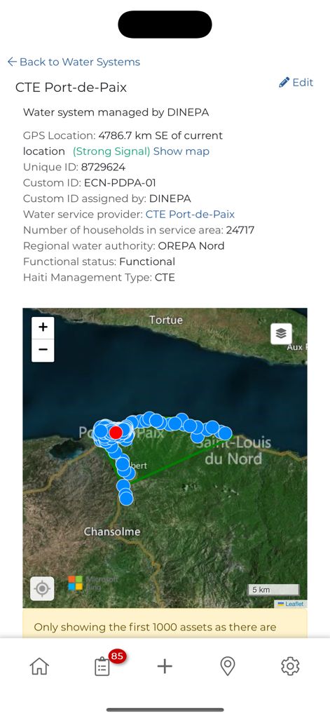 mWater Surveyor - Mobile screen displaying water system infrastructure data and a geographical map with markers in mWater Surveyor.