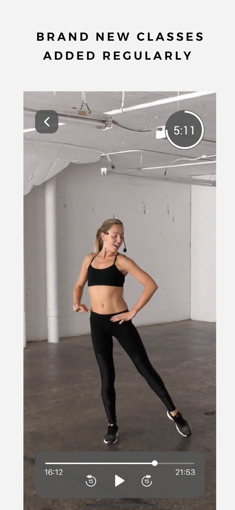 OMFIT - 1,000+ Fast Workouts - A female fitness trainer teaching a workout class in the OMFIT mobile app video player.