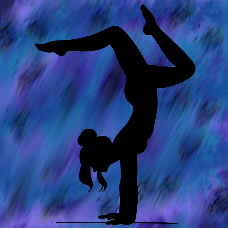 a woman doing a handstand