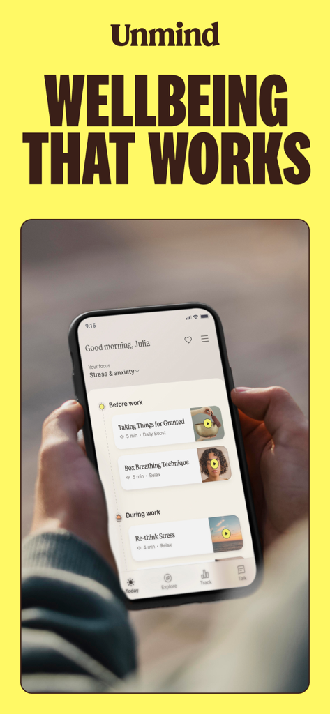 A person holding a smartphone displaying the Unmind app dashboard with personalized wellbeing exercises for stress and anxiety.