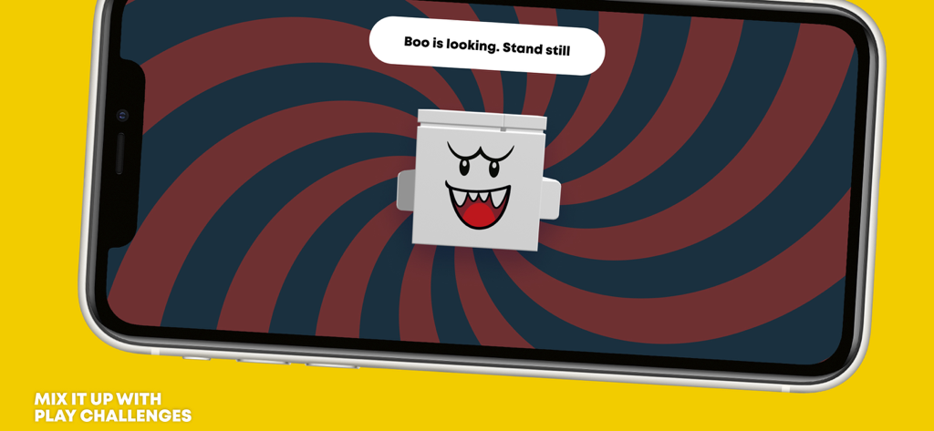 A screen from the LEGO Super Mario app featuring a Boo character play challenge with instructions to stand still